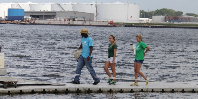 three students working on the river