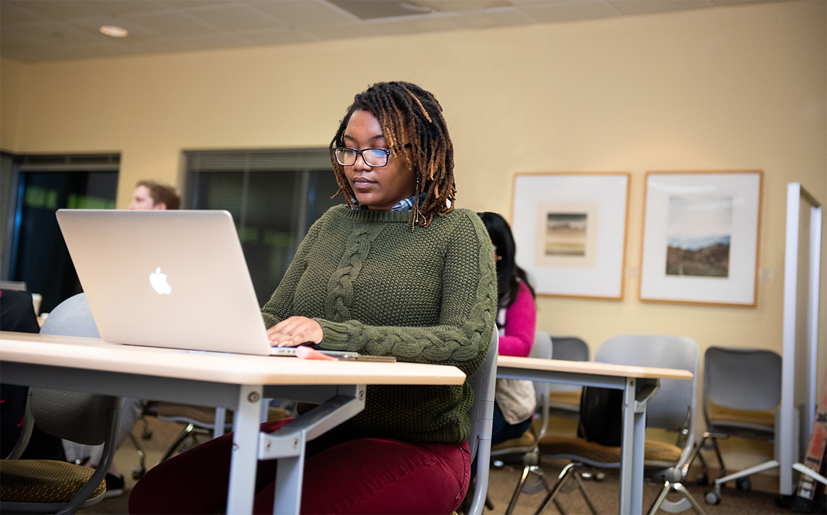 Graduate student studying at computer