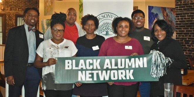 Alumni with banner