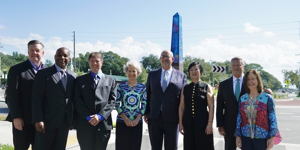 People posing for picture in front of Obelisk