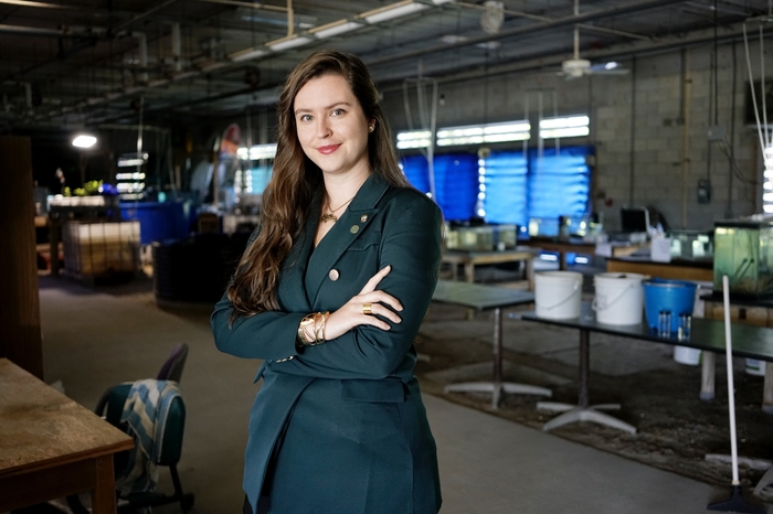 A female student posing in the Marine Science Research Lab