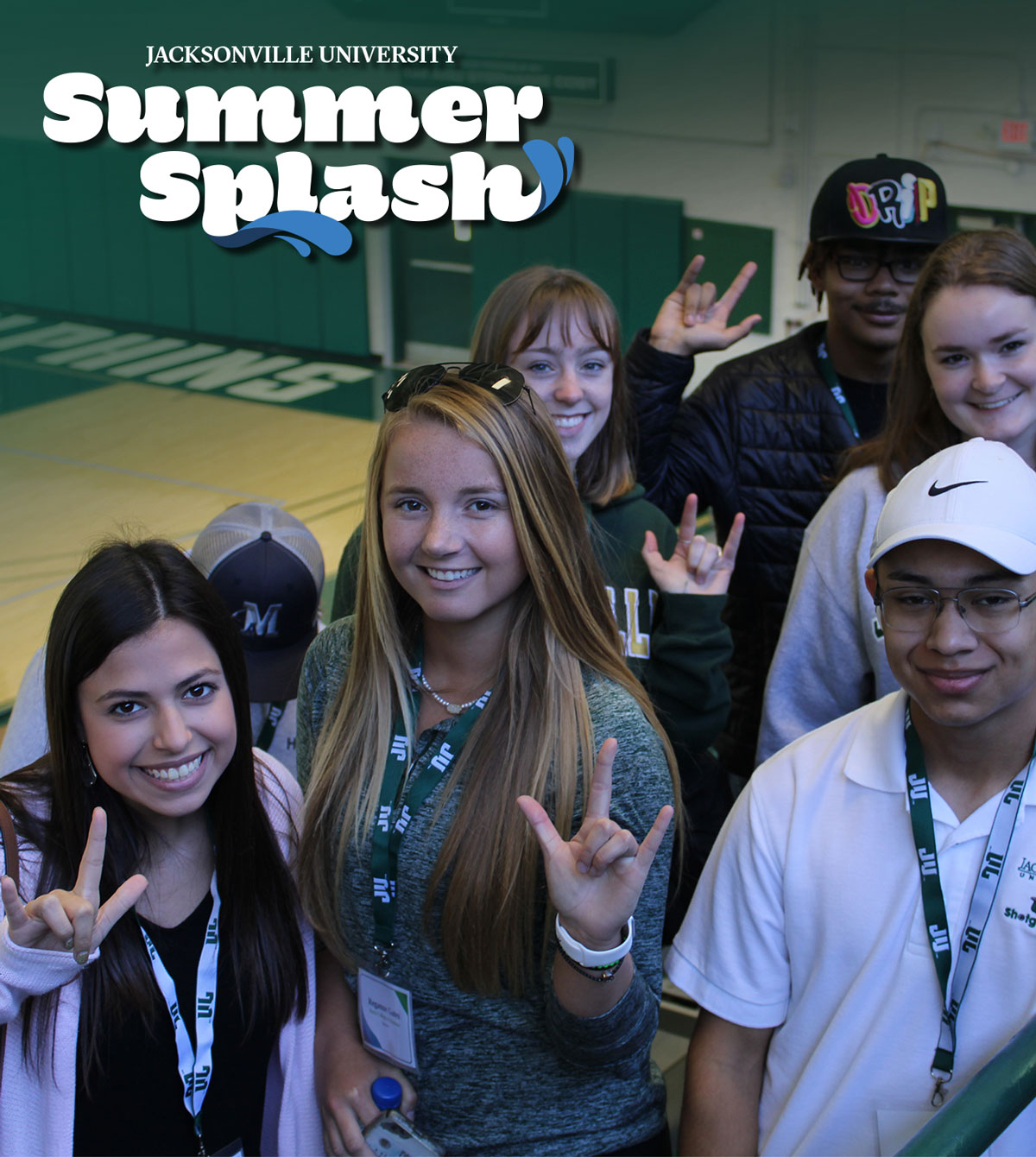 Future students posing for a photo in Historic Swisher Gymnasium.