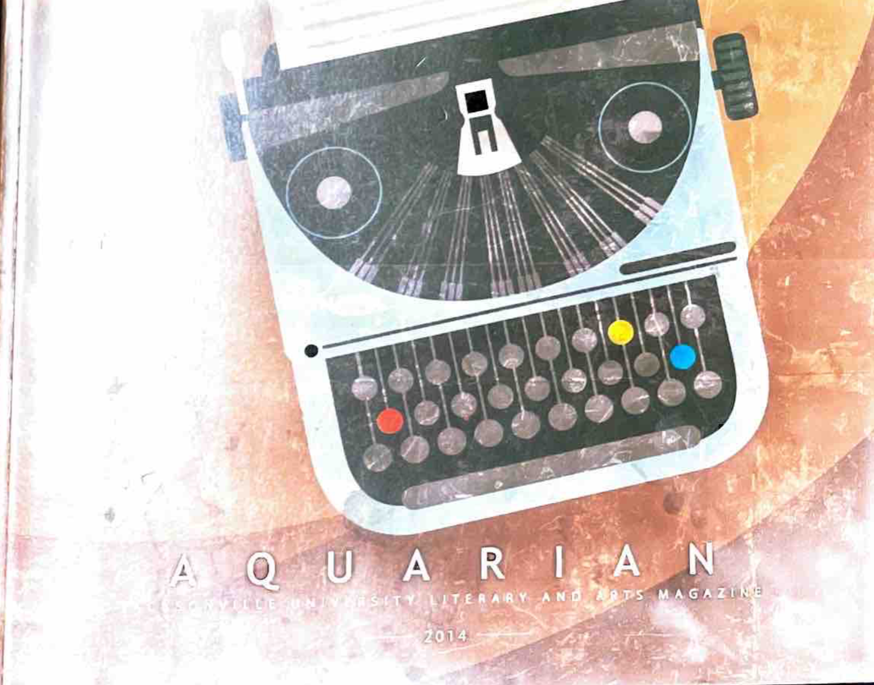 2014 Cover with a grey and blue typewriter, a brown background,and the Title Aquarian