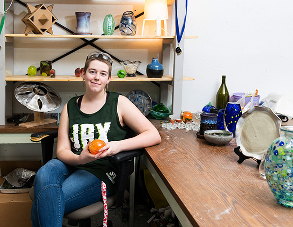 A student poses with some of her work.