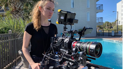 Alumni Natassja Eebert on location with camera