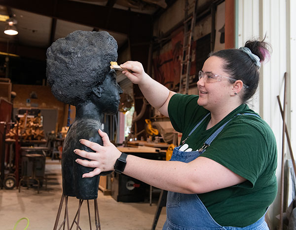 A student working on her sculpture in the studio.