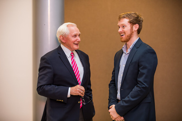 Male business student talking to male entrepreneur.