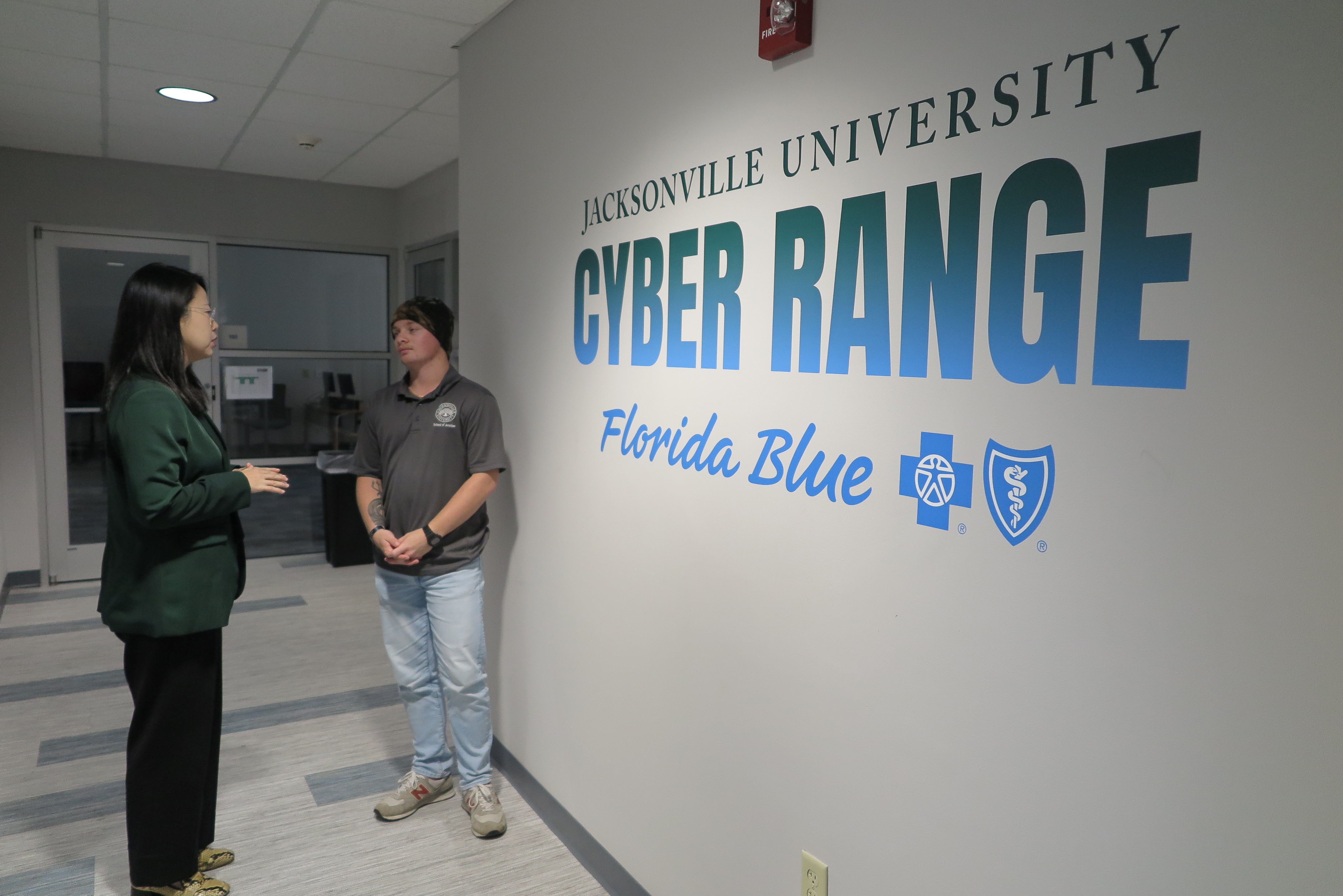 JU professor talking to student outside Cyber Range