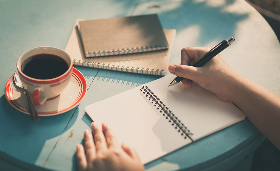 Hand writing on several pads of paper