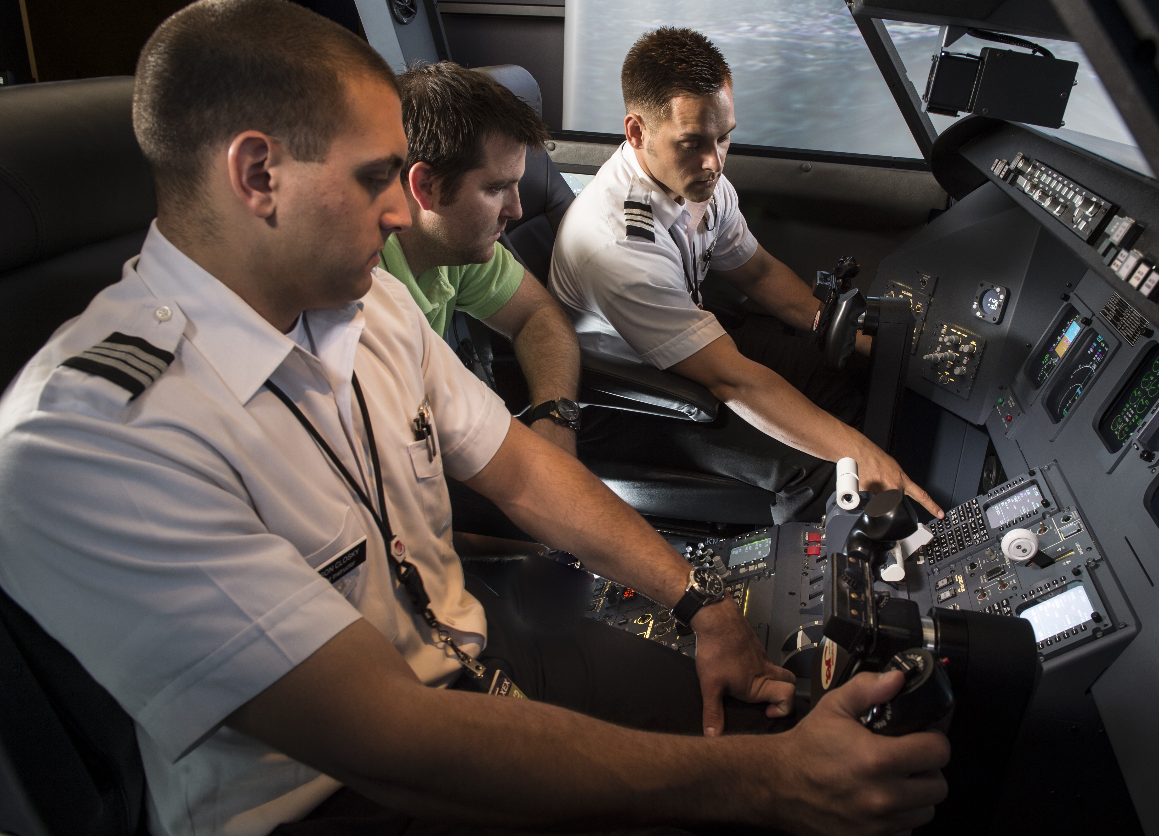 Two students in flight simulator.