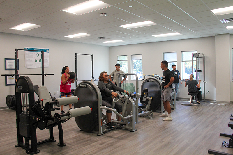 Two Exercise Science students supervise patients during free exercising