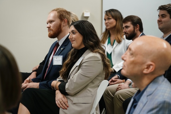 A group of law students listening to a presentation