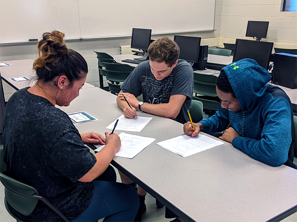 JU math students working together on a math problem.