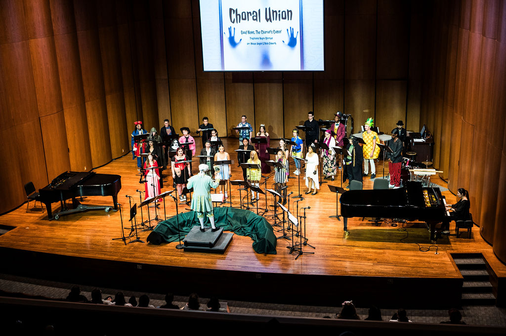 Choral students and Choral Director, Dr. Julian Bryson, practicing a musical piece.