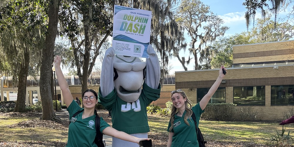 Students post with Dunk’n during Dolphin Dash