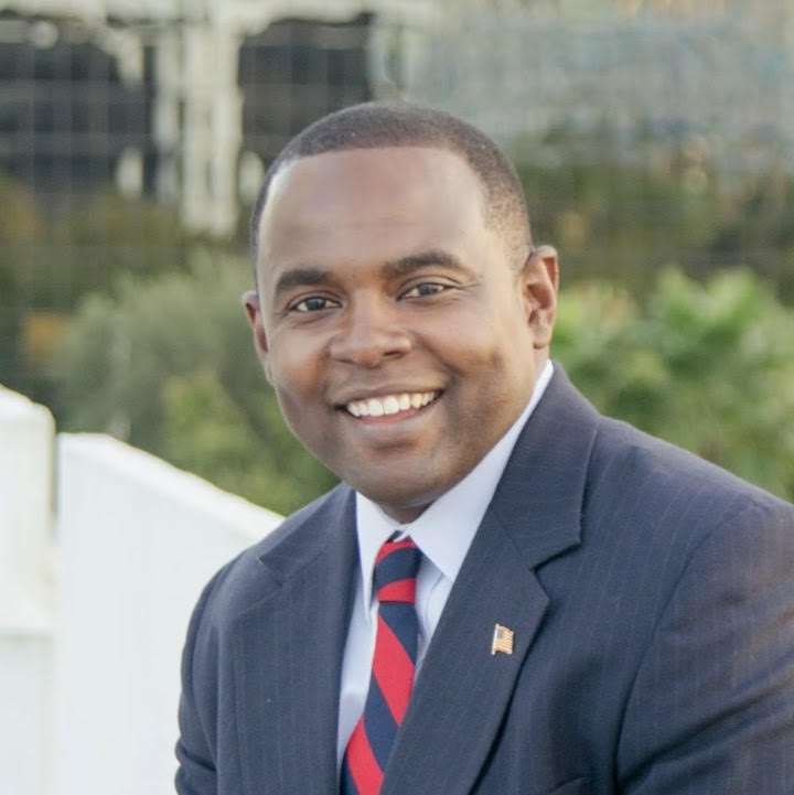 smiling african american male, blue suit, red tie