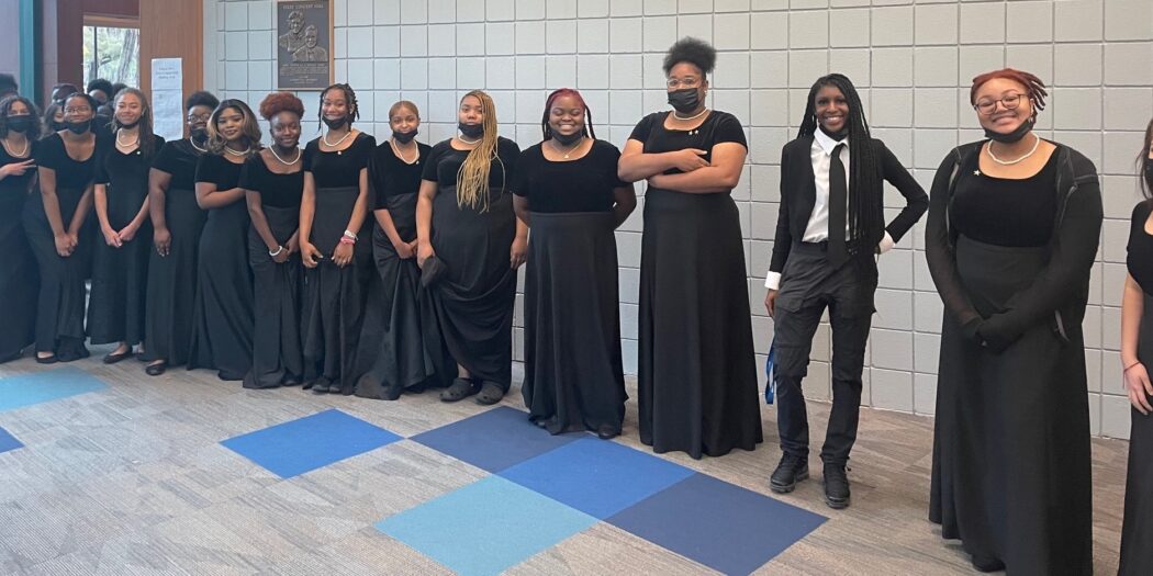 Student choral singers standing in a line