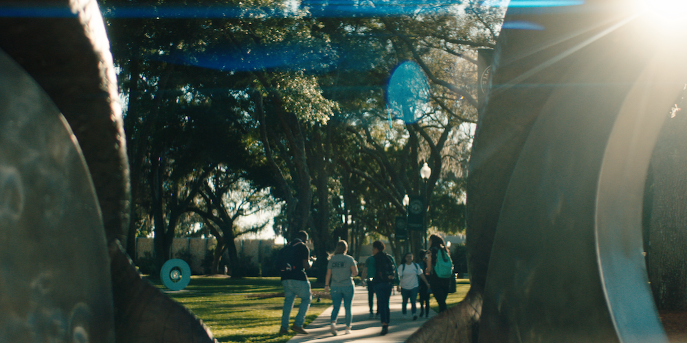 students walking on science green