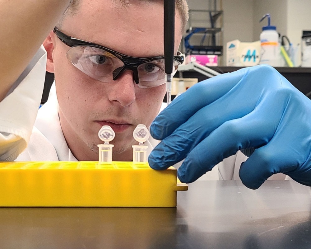 JU chemistry student Tyler Kopf performs lab work. 