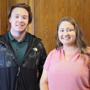 Two students stand together after facilitating the meeting