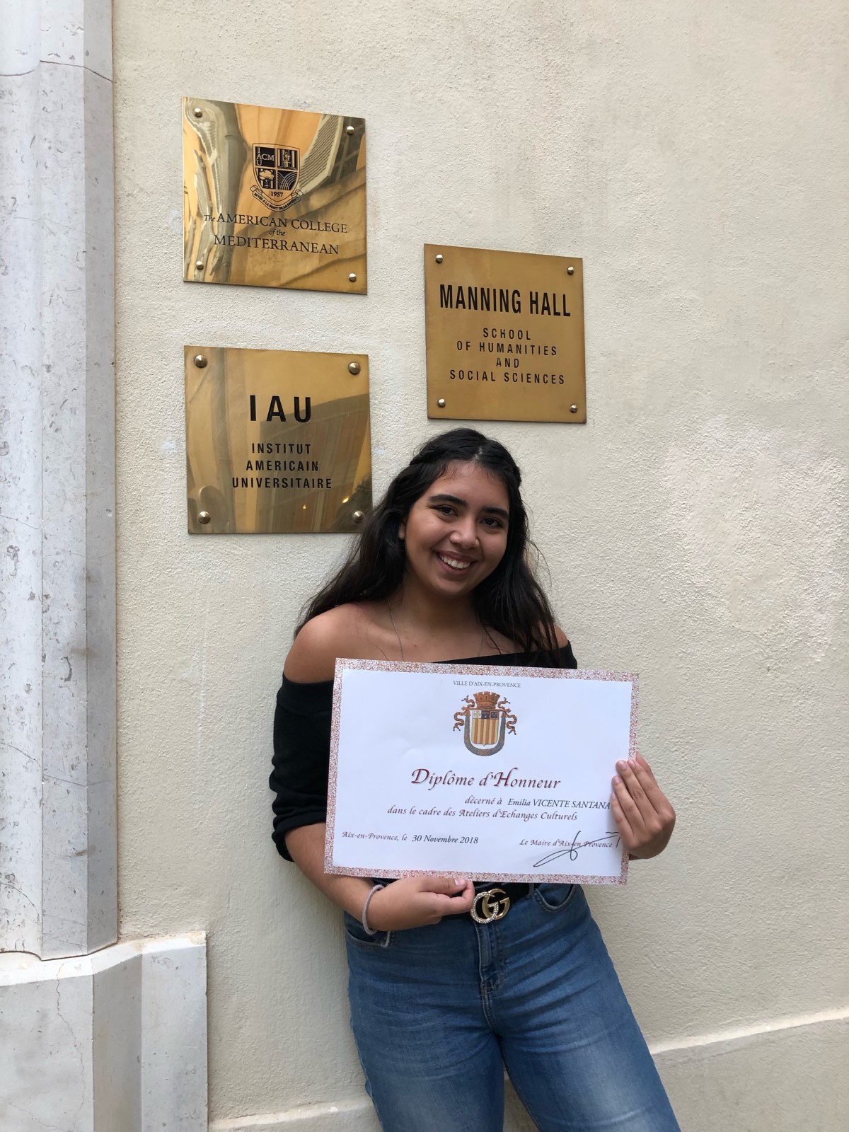 Emilia holding her diploma of honor