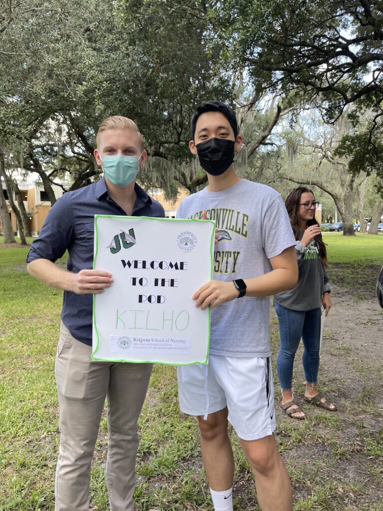 A male nursing student standing next his new student mentee.