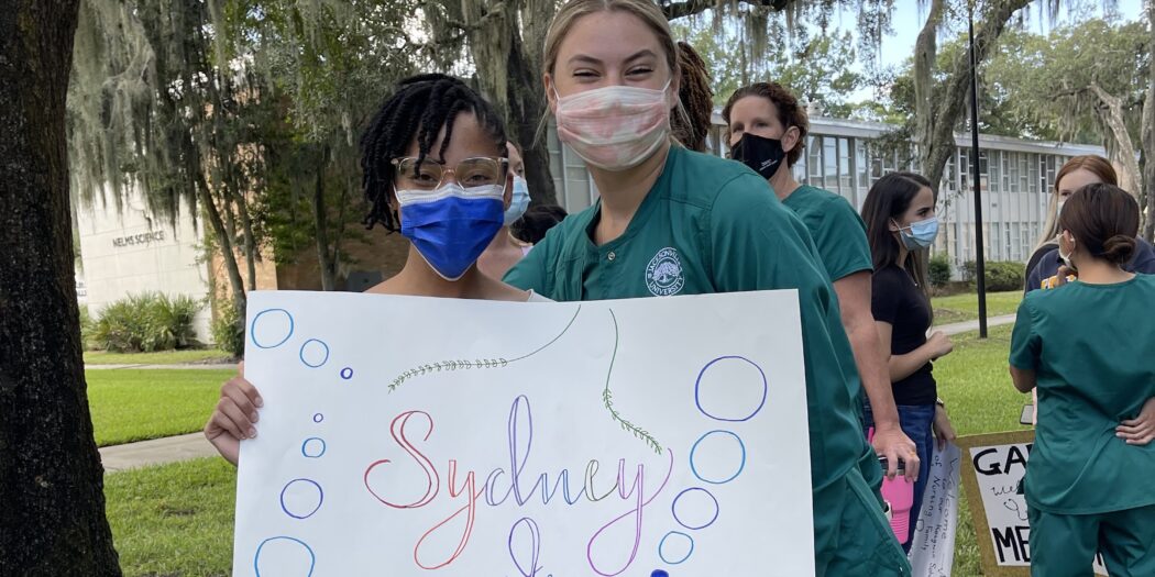 A female nursing student posing for a photo with her new student mentee.