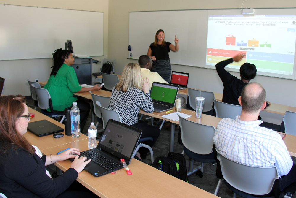 Dr. Whitney George teaching gradaute clinical mental health counseling students in a classroom