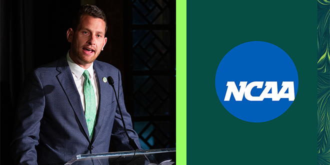 Alex Ricker-Gilbert standing in front of a podium, next to the NCAA logo.