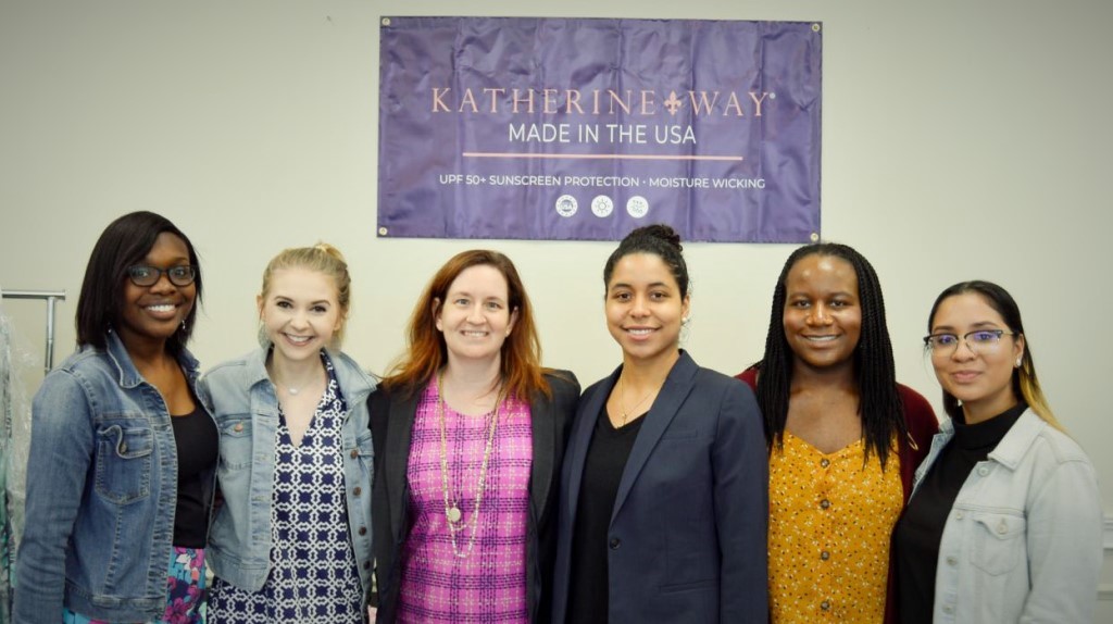 Five members of the Phin Communications team standing with Dr. Courtney Barclay in the middle.