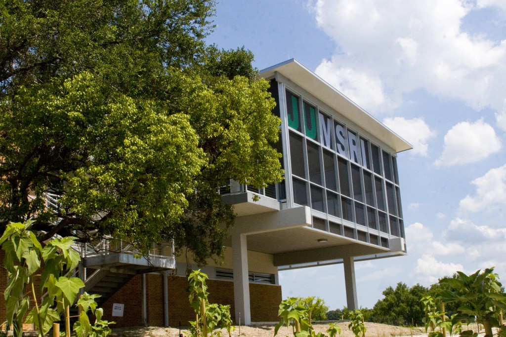 large building surrounded by trees and blue sky with letters JU MSRI