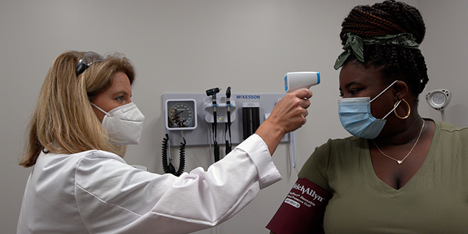 A nurse taking a student's temperature.