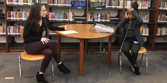 Allison Ventrone (left) and fellow student Camisha Hatcher prepare to conduct hearing screenings in a local elementary school (pre-COVID).