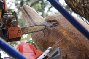 man sculpts dolphin