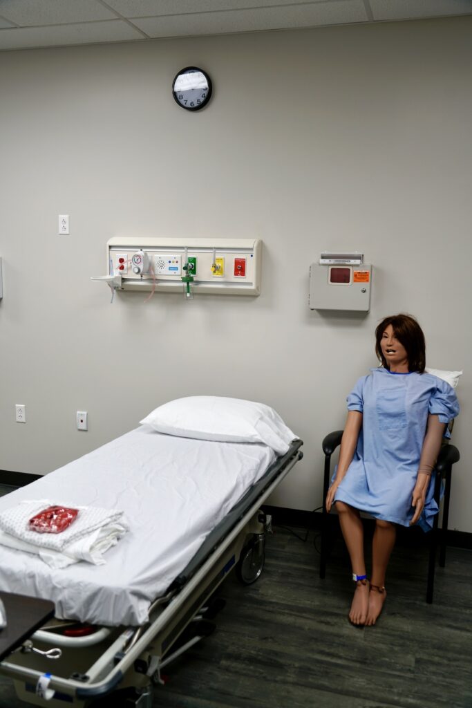 empty hospital bed and manikin