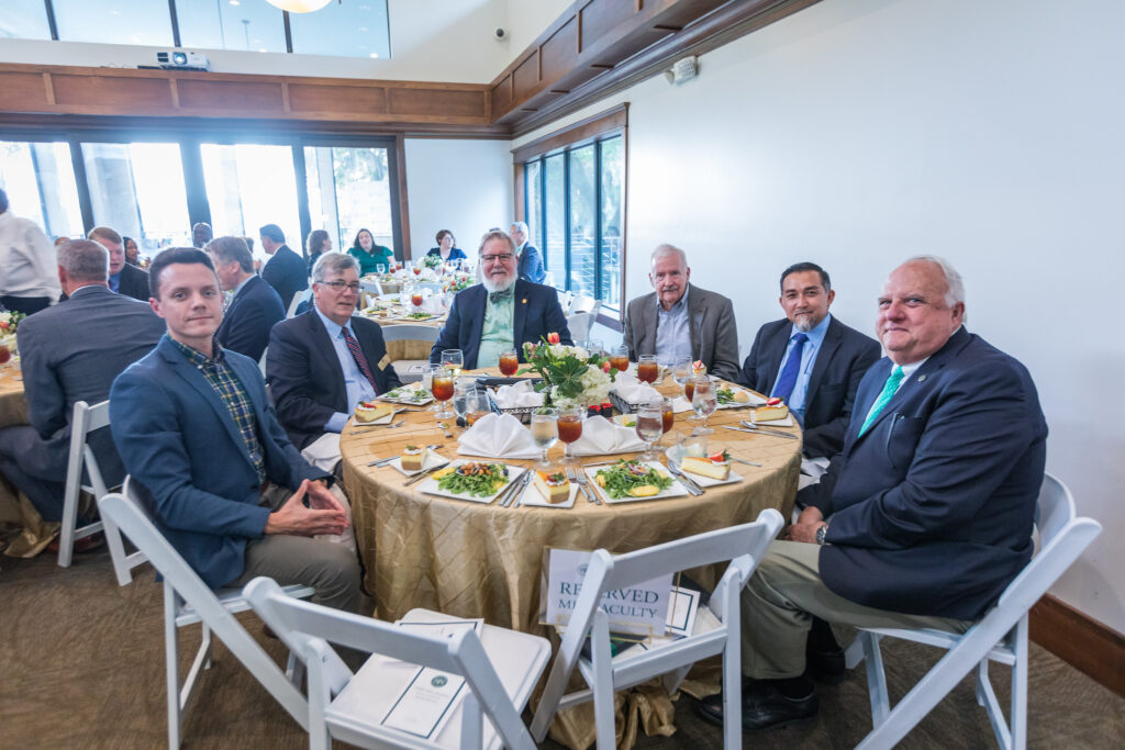 faculty sitting at a table 