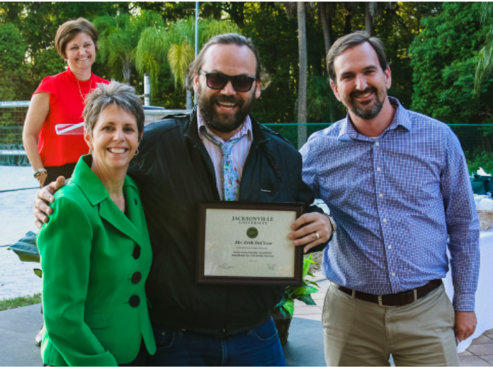 Professor DeCicco (middle) is recognized with the Faculty Excellence Award for University Service. Photo by Taylor Sloan.