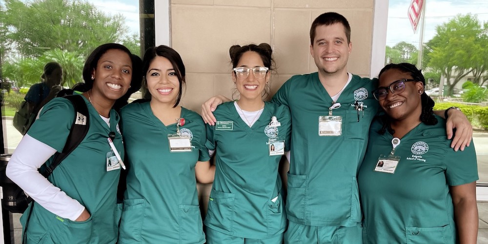 nursing students pose in between classes