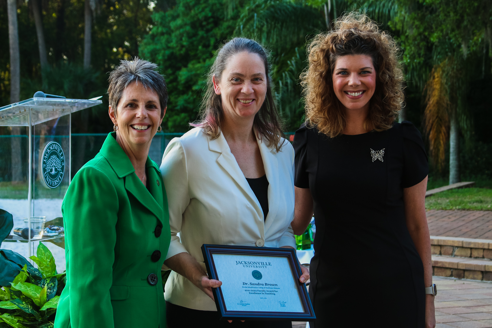 Dr. Brown (middle) is recognized with the Faculty Excellence Award for Teaching. Photo by Taylor Sloan.