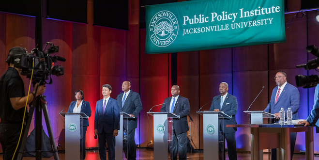 Candidates and Rick Mullaney on stage at the debate