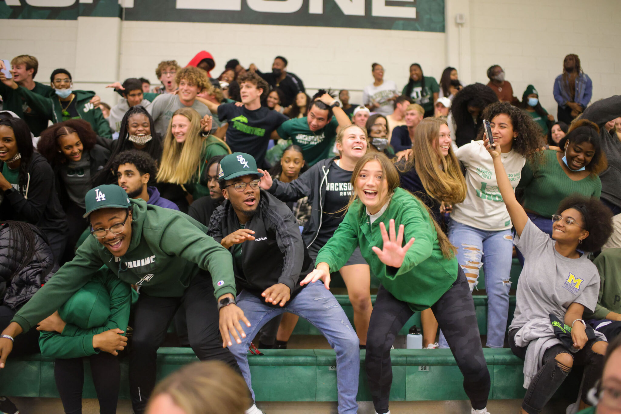 students celebrate at mens basketball game