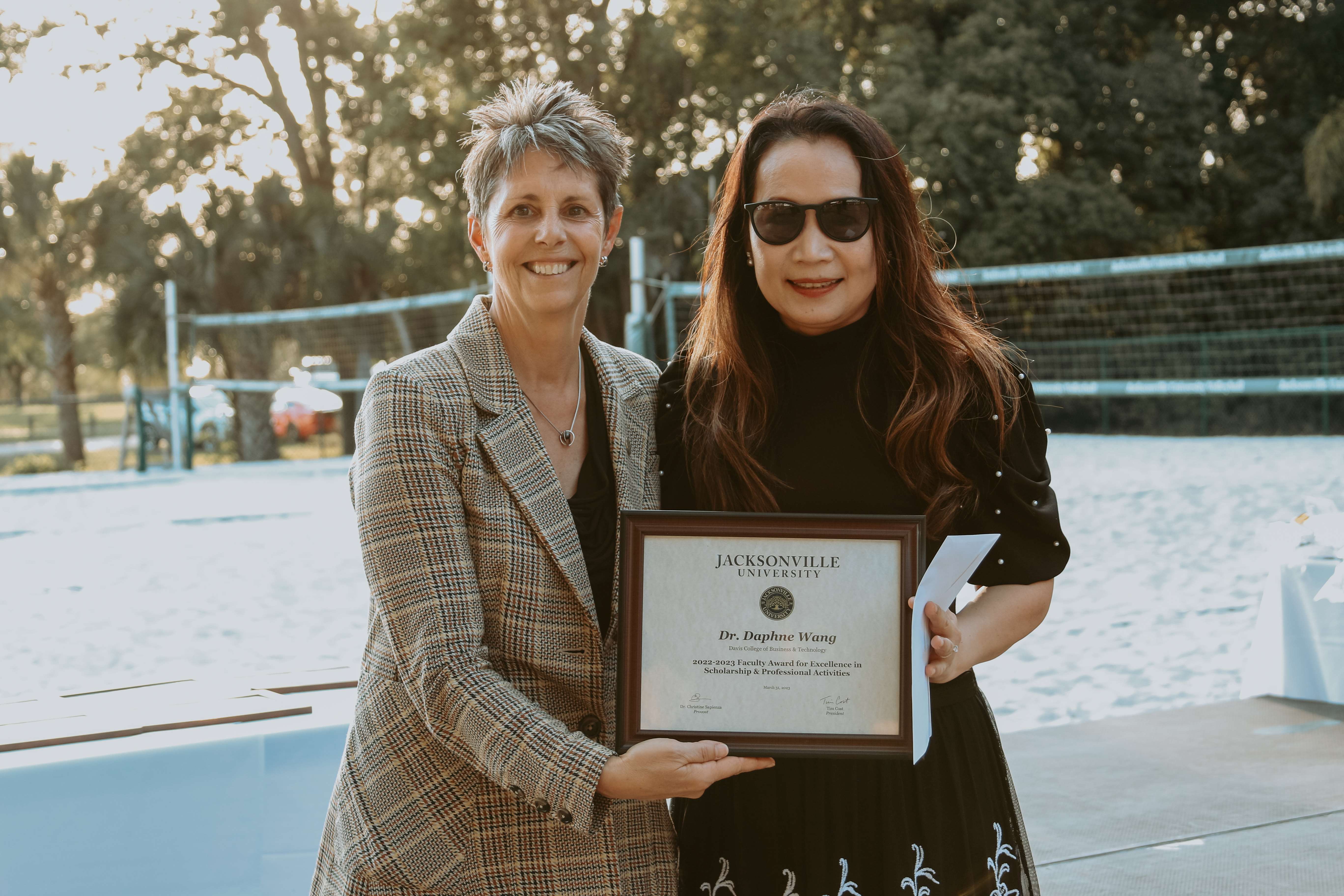 two women holding an award