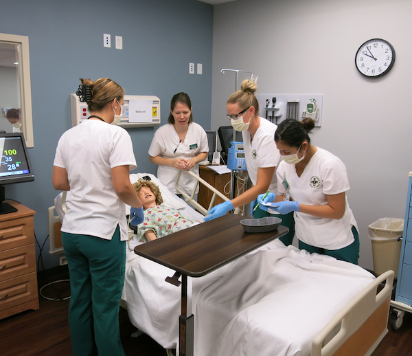 Nursing students working inside a laboratory setting. 