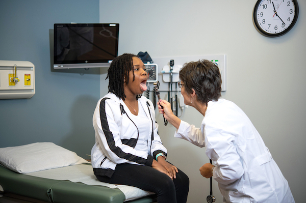 A nursing professional giving a check up to a patient.