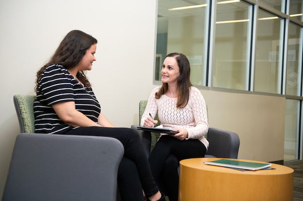 A mental health Nurse Practitioner talking to a patient.