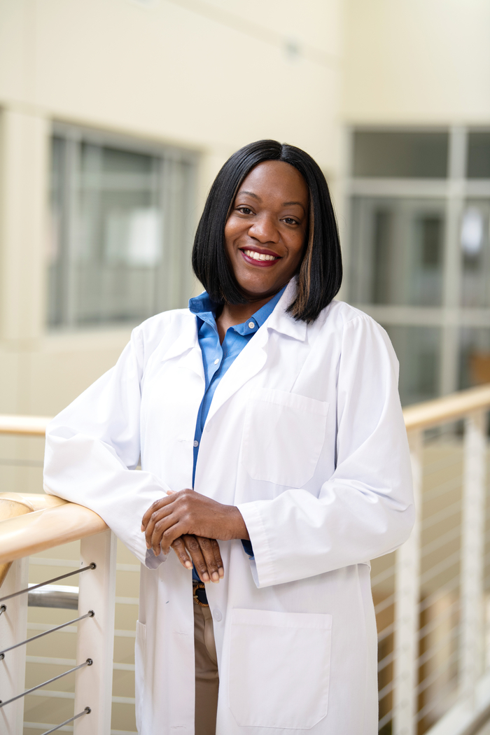 A woman posing in her white coat