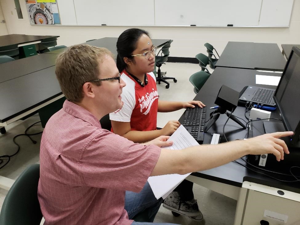 Brian Lane helping student with eye tracking