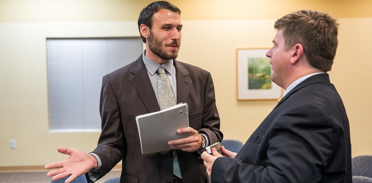 Two male Public Policy students having a conversation.