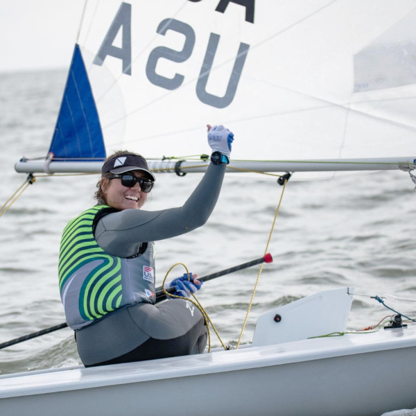 A sailing woman celebrating a win inside a sailing boat