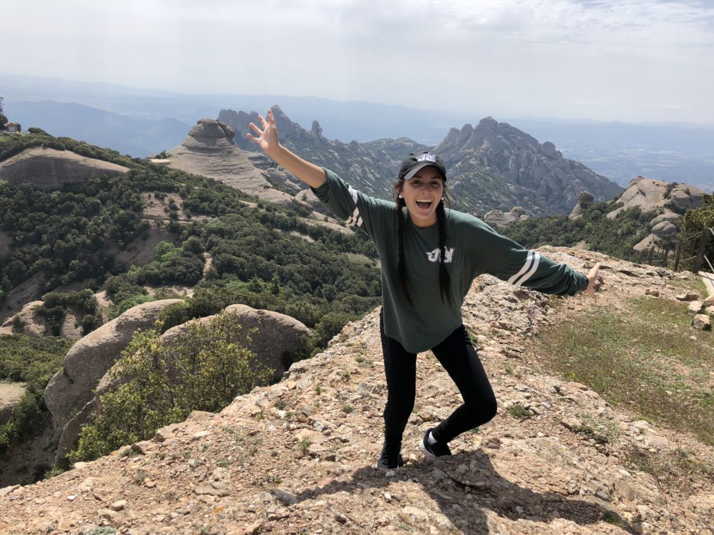 Amanda posing in front of mountains in Spain.